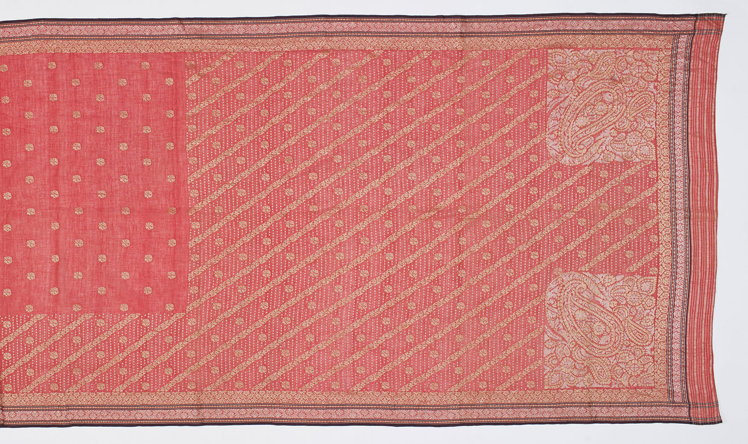 A Jamdani saree with a central field of circular floral motifs, dense borders and squares of paisley motifs in each corner.