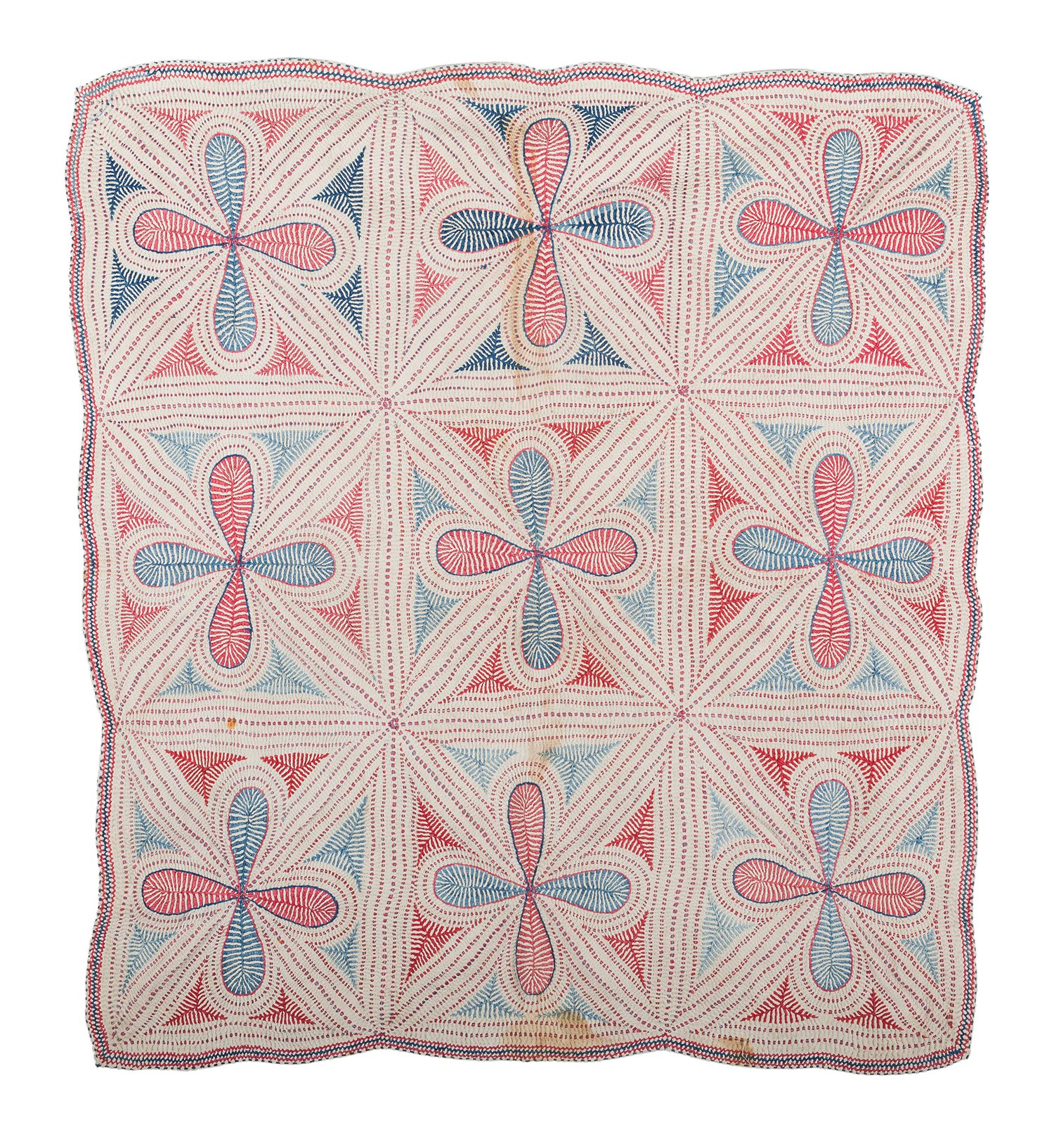 A patchwork dotted Kantha showing four-petalled flowers arranged in a grid of nine cells.
