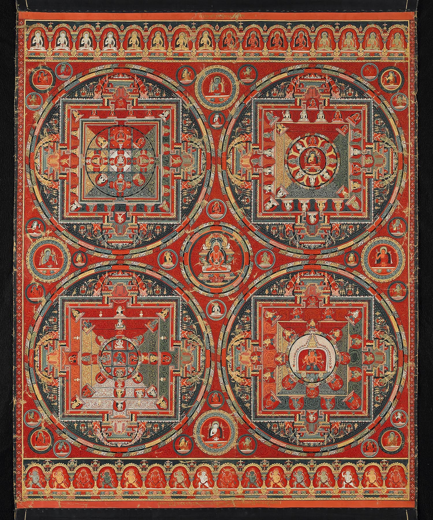 A Buddhist thangka with four circular mandalas, and religious figures in the main field and the borders.