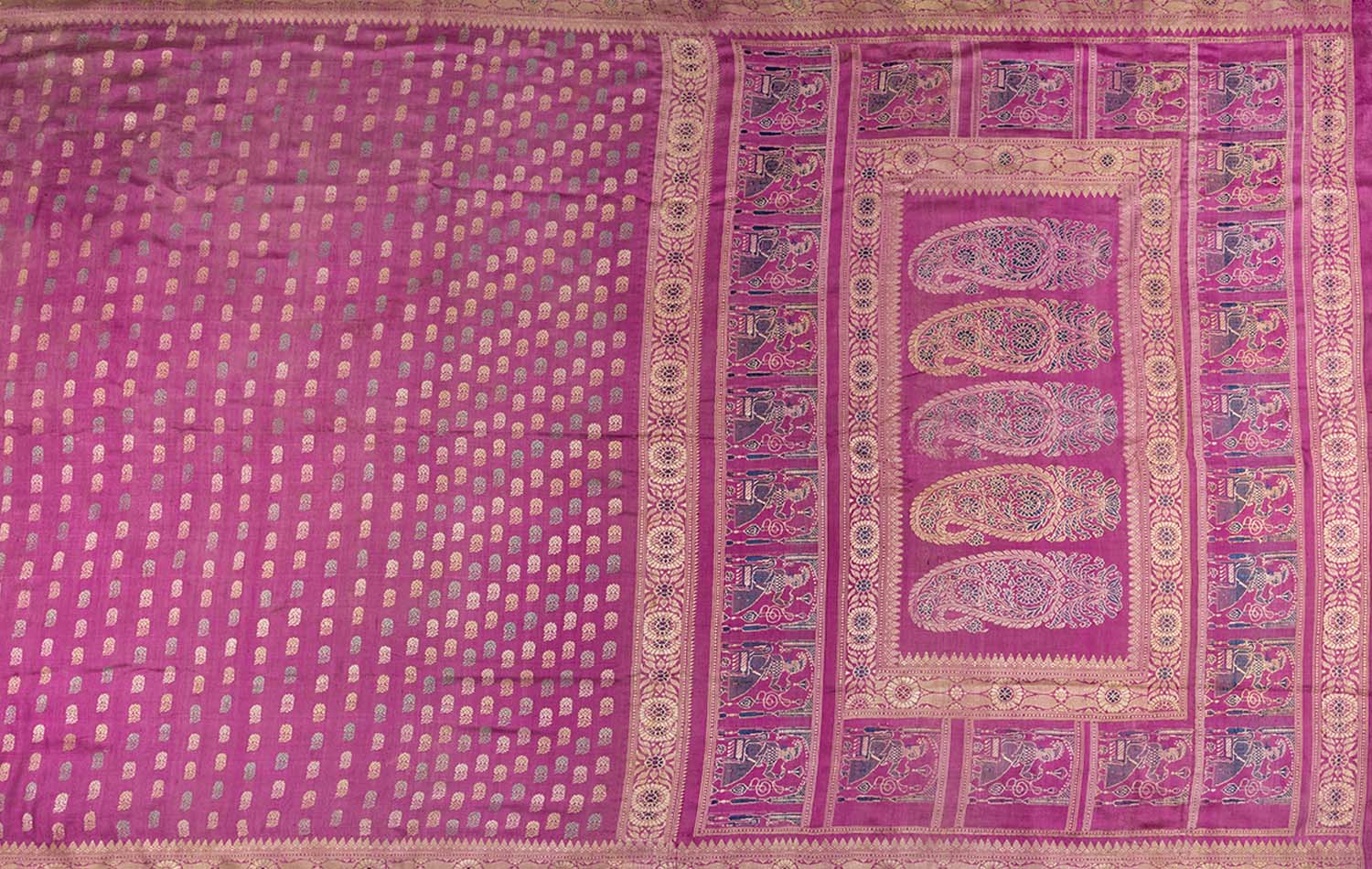 A Baluchari saree pallu bearing paisley motifs within a rectangular border composed of a repeating figure of a seated man.