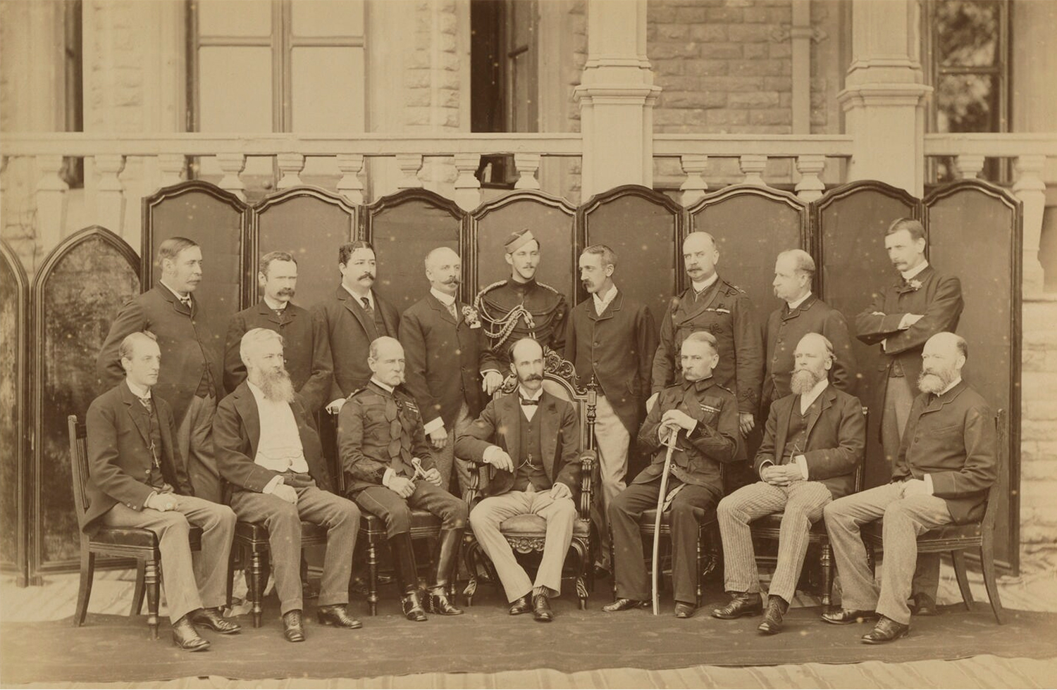 A sepia-toned group photograph of civil servants of the British administration in India.