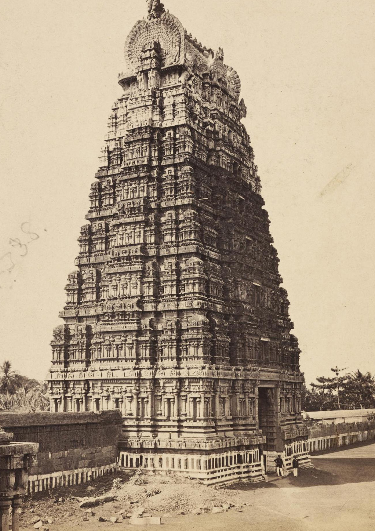 A sepia-toned photograph of the principal gopuram of a temple in Kanchipuram, Tamil Nadu.