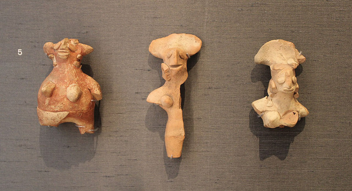 Three fragments of terracotta figurines with feminine anatomical features.