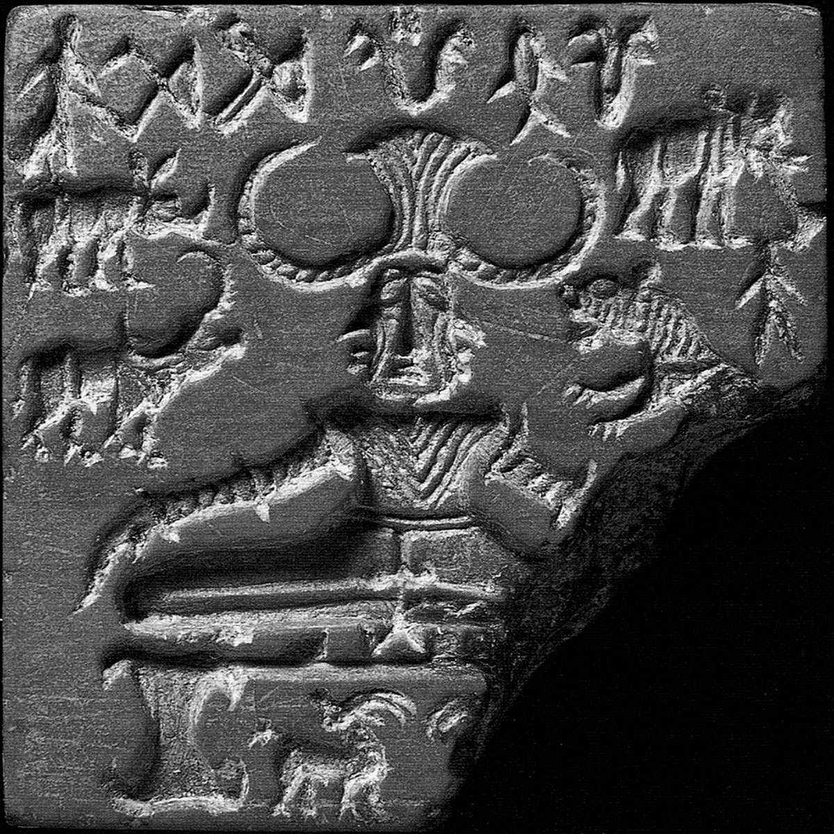 A steatite seal depicting a seated figure with tricephalic features and surrounded by animals and the Indus script.