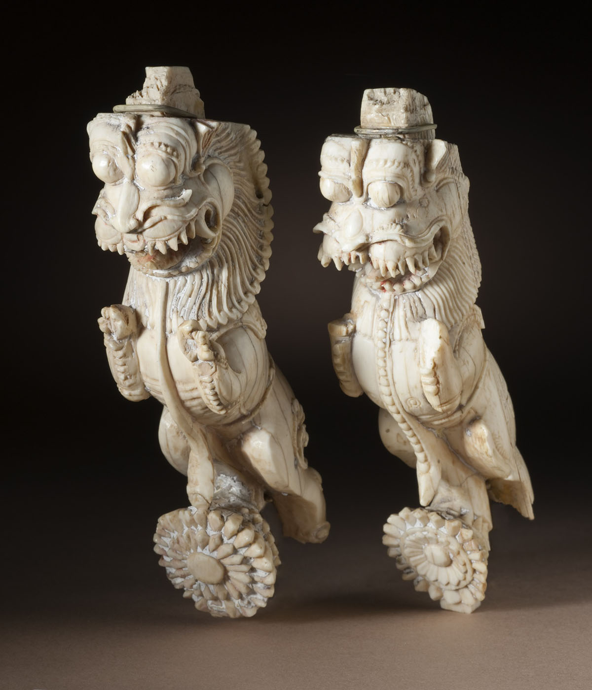 A pair of architectural brackets depicting the mythical creature yali who is part lion, elephant and horse.