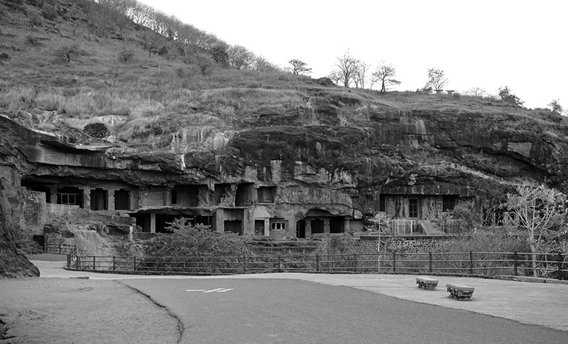 Photograph of Caves 1 to 9 at Ellora in the hillside, seen from a distance