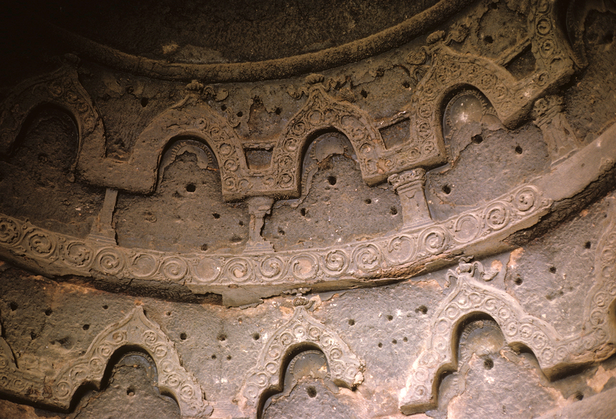 Archival photograph showing niches made out of plaster on the walls and ceilings on the caves in Bamiyan valley