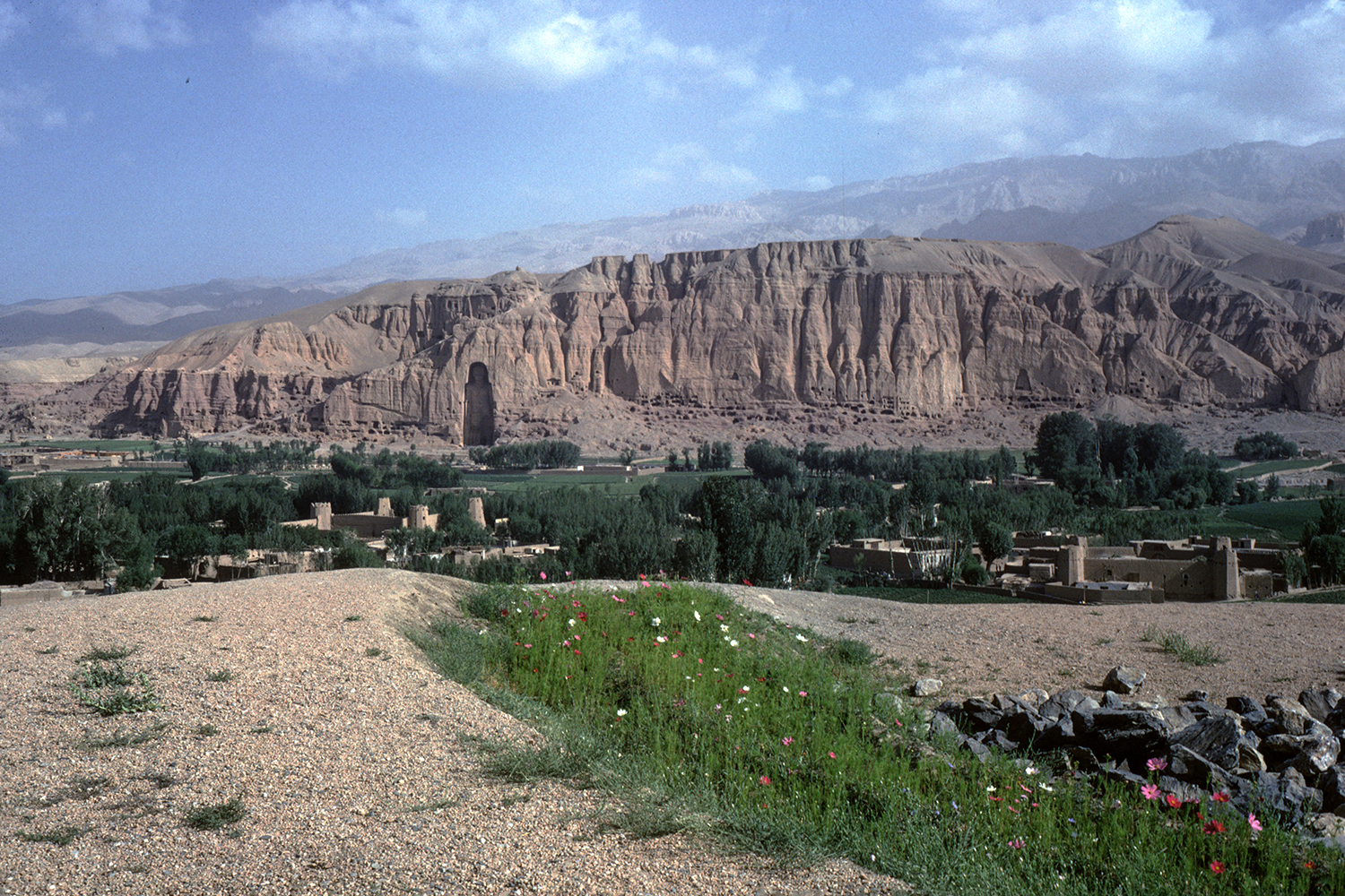 Archival photograph by Francoise Foliot showing a distant view of the cliff face with the western Bamiyan Buddha