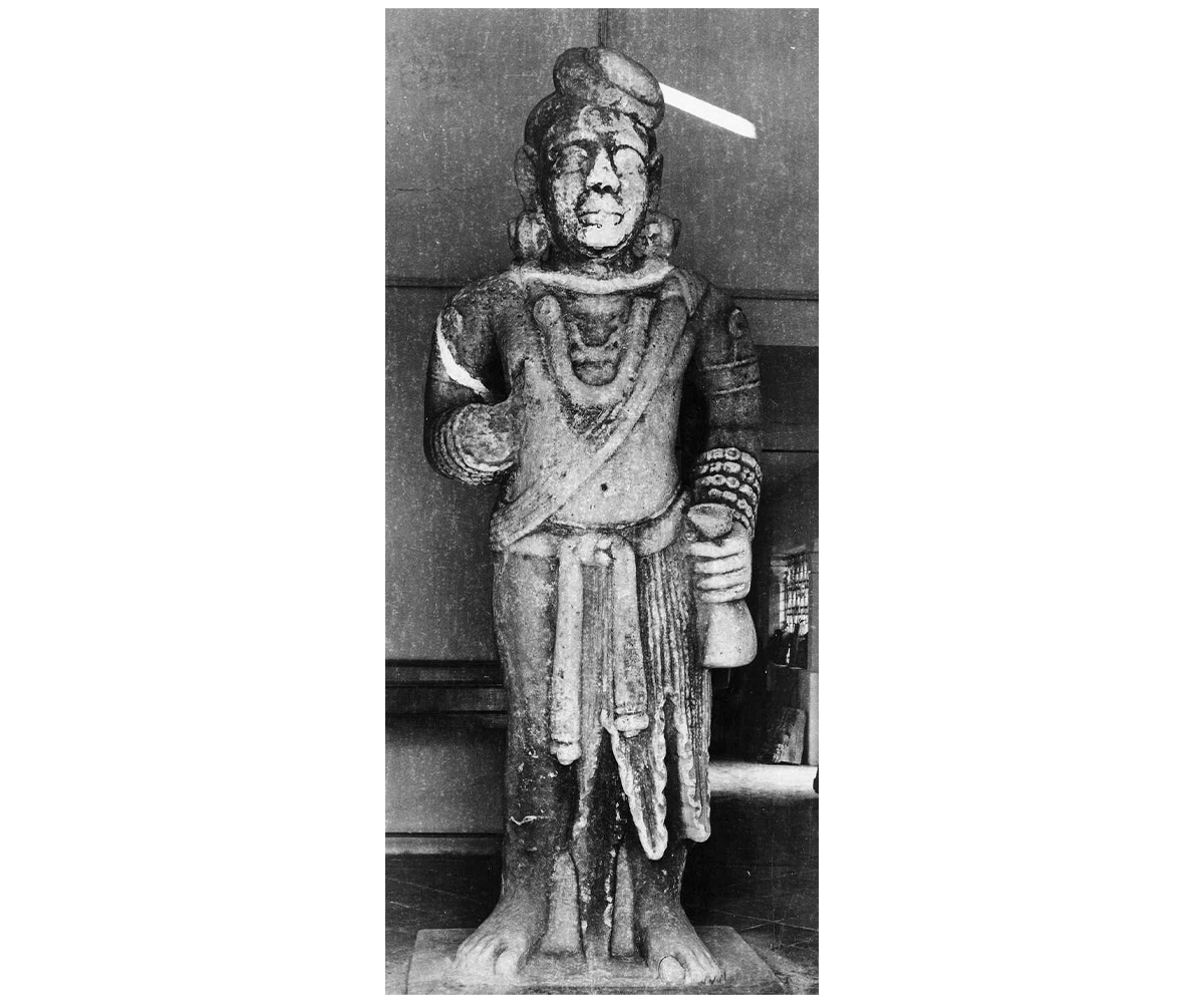Black and white photograph of the standing sandstone Kubera yaksha from Besnagar now housed in the Vidisha Museum