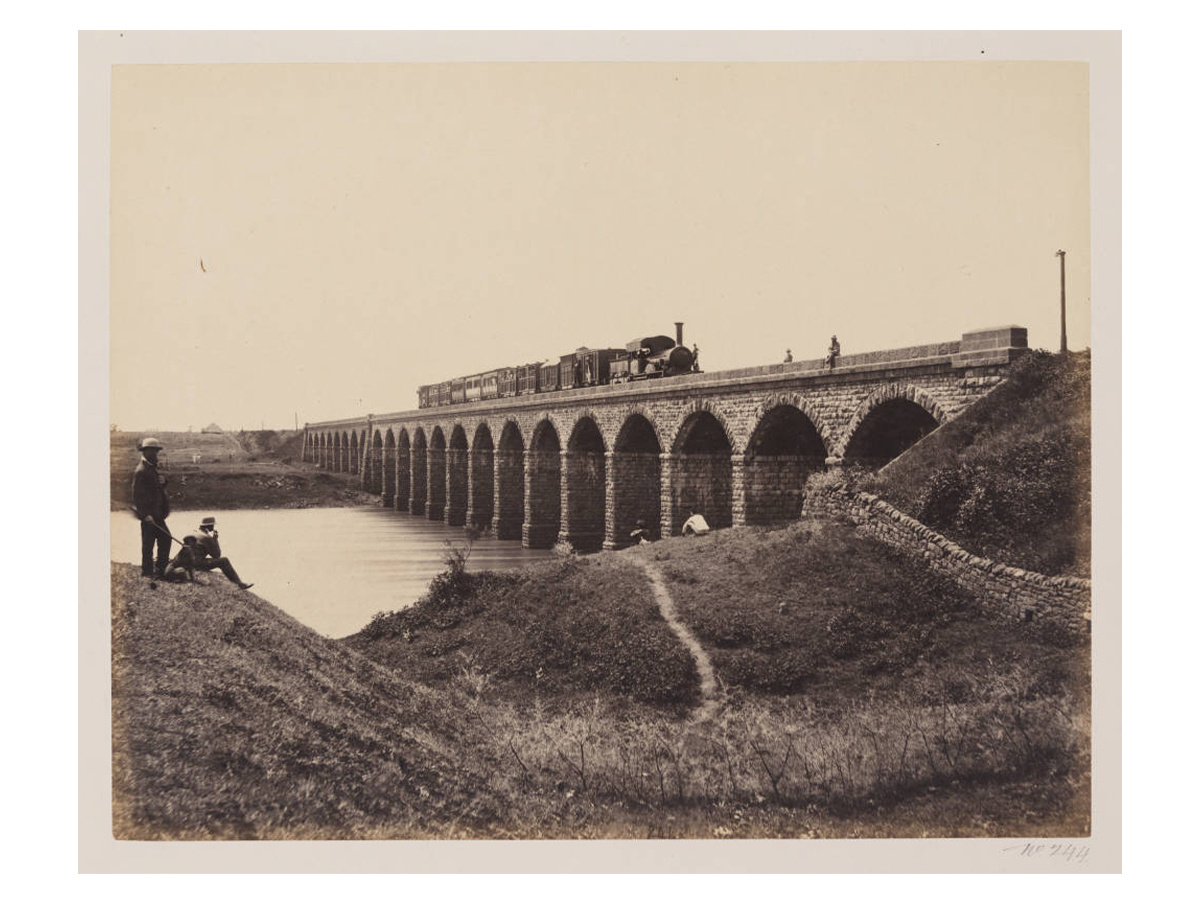 Mid-19th century photograph by William Johnson showing a train on a bridge above a river