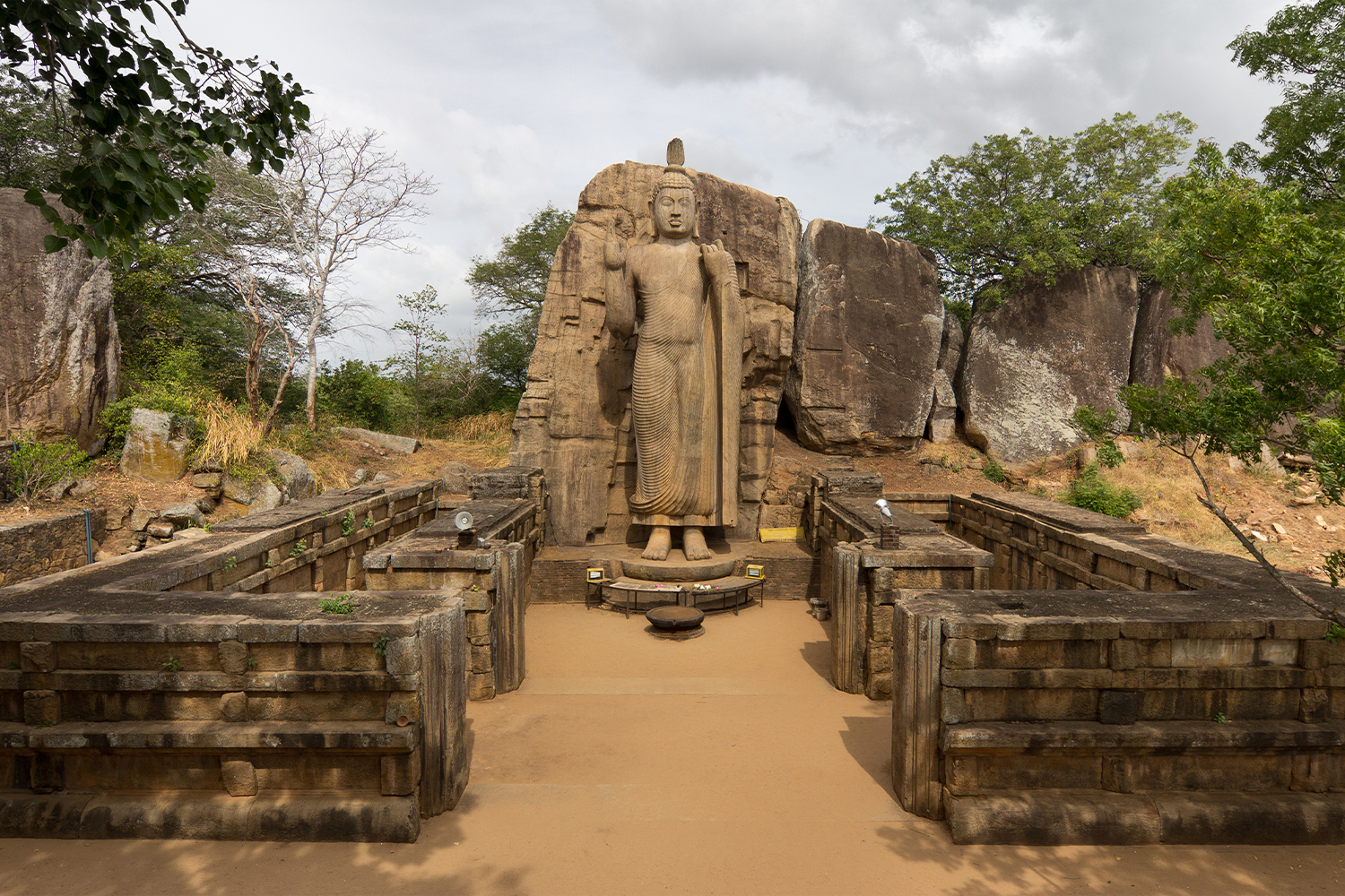 Photograph of the Avukana Buddha statue and shrine wall remains from the front