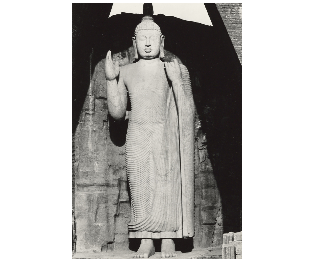 Archival photograph of the standing Buddha statue at Avukana by Jean Dupin