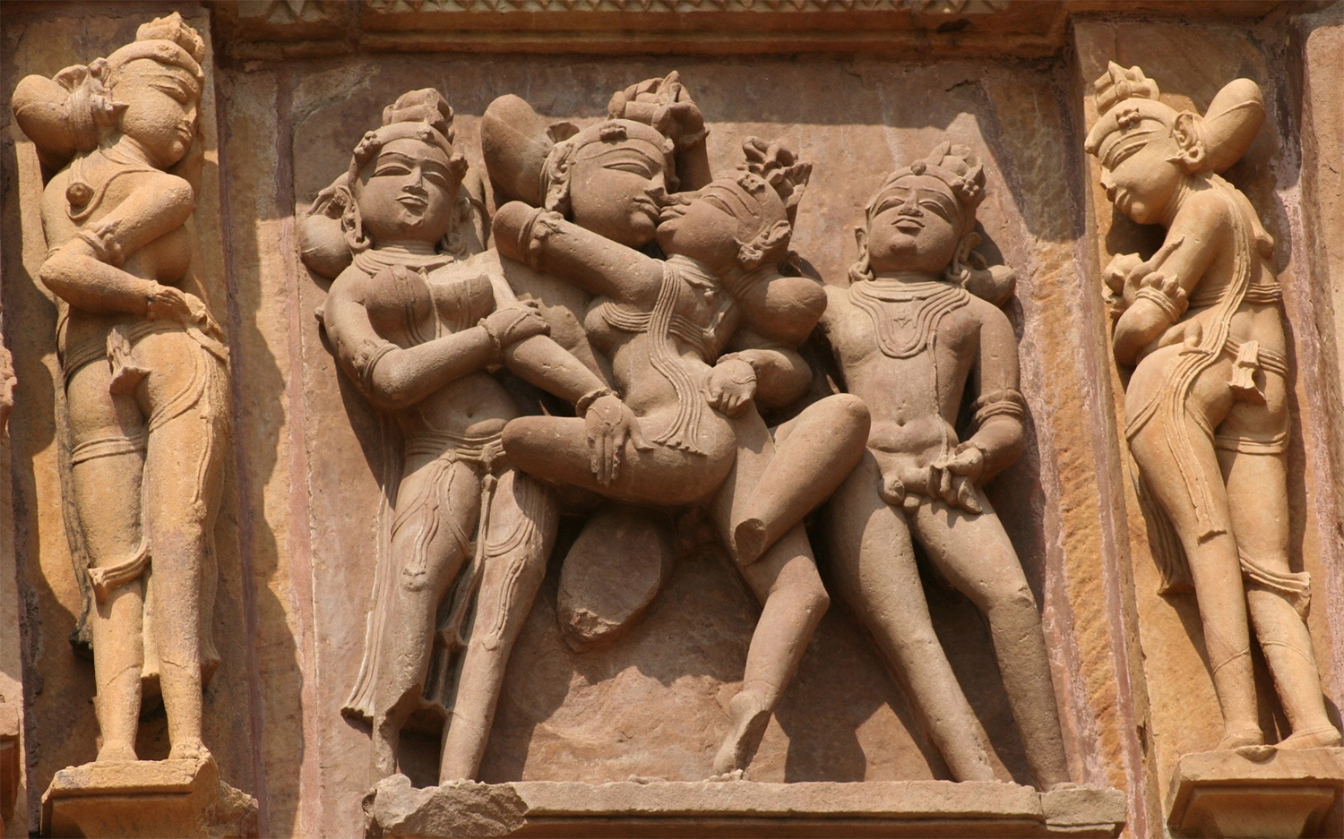 Photograph of a mithuna relief showing a couple copulating surrounded by attendants